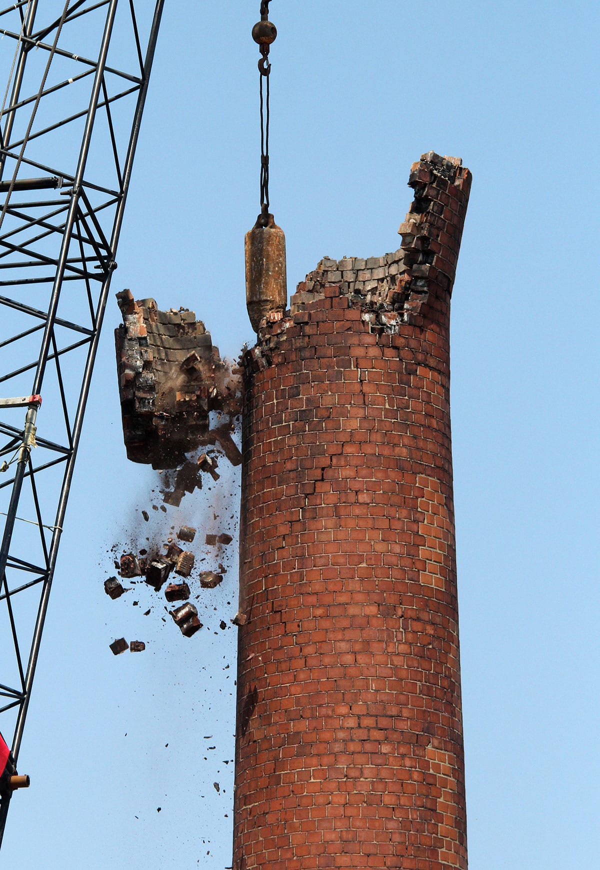 The chimney at 175 Alley St. in Lynn is being taken down one small section at a time.