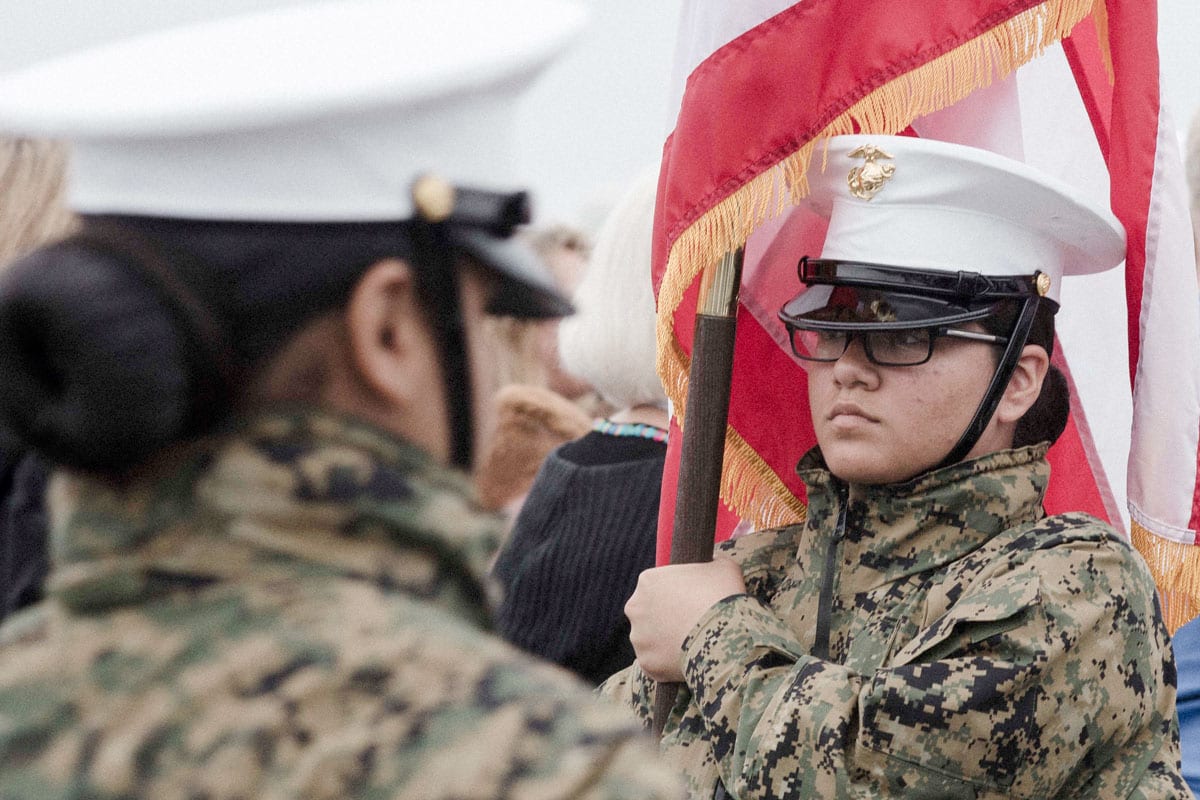 Cadet Major Leslie Chinchilla, a student of Lynn English High School, parades the colors during a ceremony aboard USS Whidbey Island for the Parade of Sails during Sail Boston 2017.