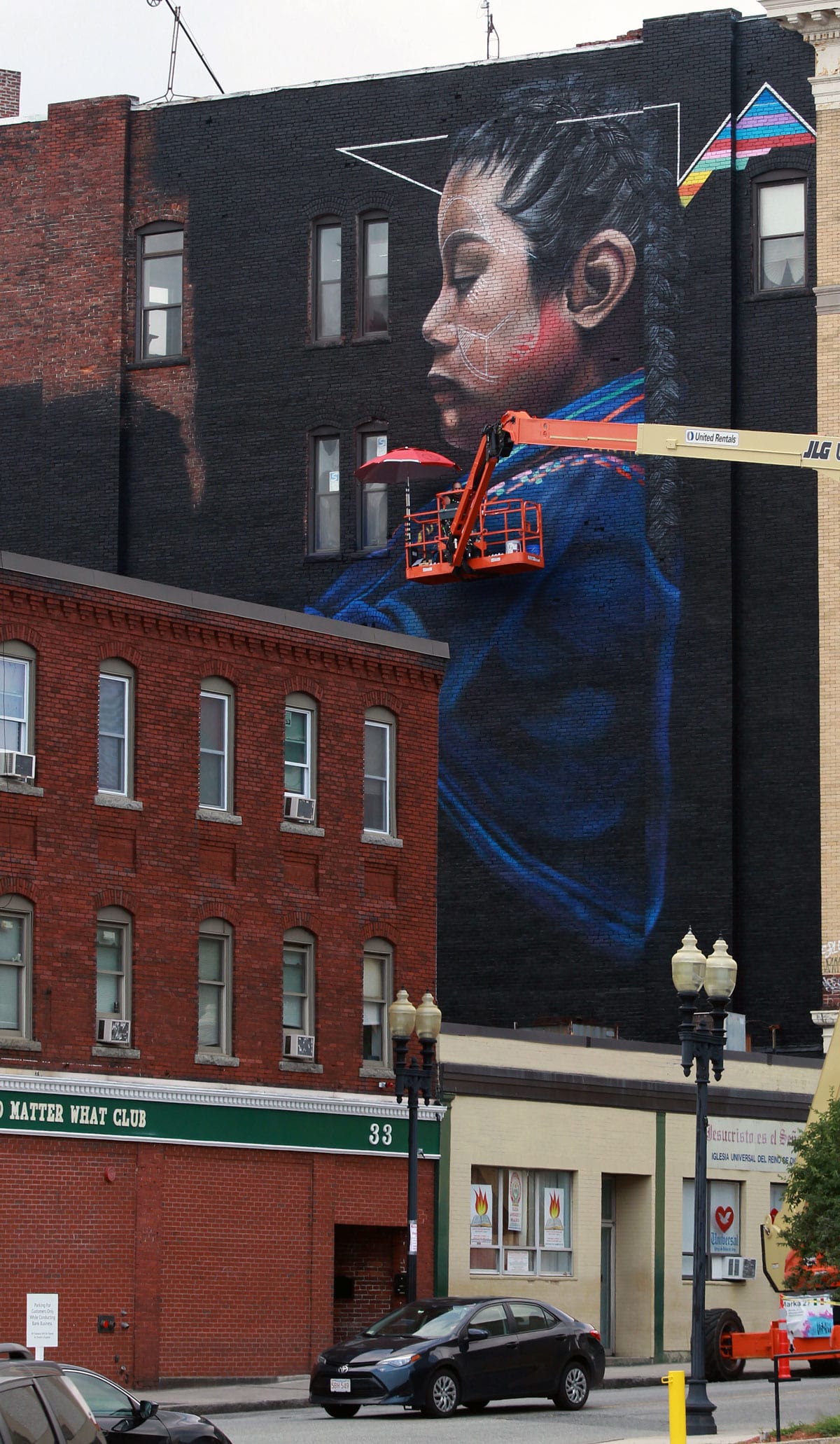 At right, a mural painted on the building at the corner of Spring and Exchange streets by Mexican-born and New York City-based artist Marka27.