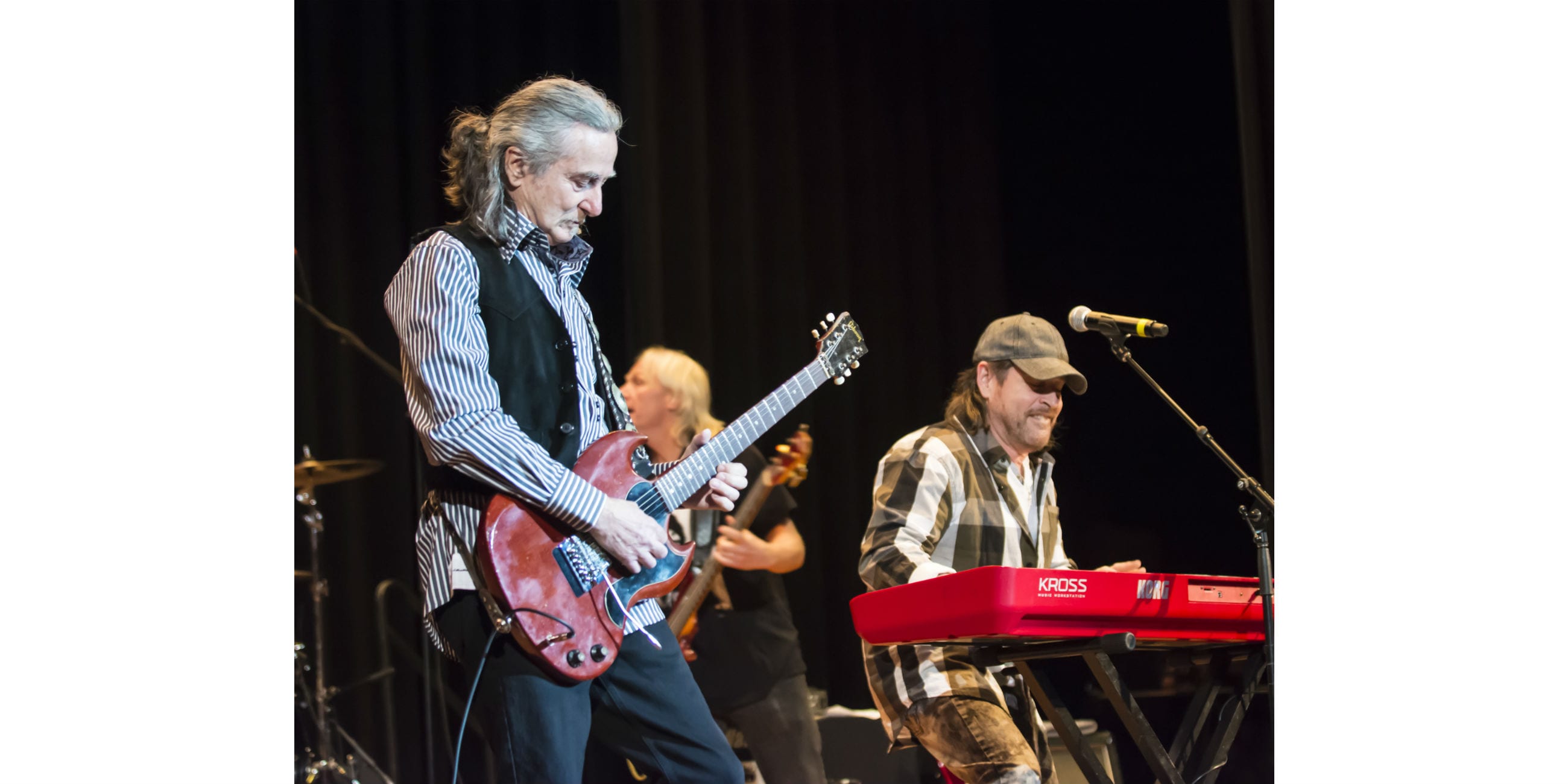 Brian Maes on the keyboard with guitarist Barry Goudreau in concert at Lynn City Hall auditorium.
