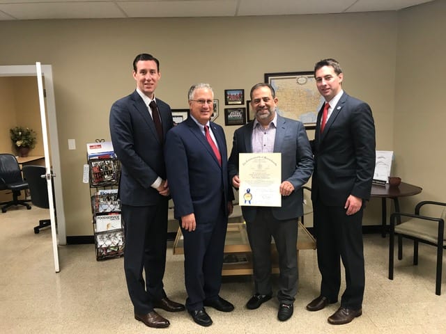 Sidekim Foods' Peter Mikedis (third from left) was recognized for his civic leadership from Mayor Thomas M. McGee (second from left), and state Rep.s. Brendan Crighton (right) and Dan Cahill. Mikedis received a citation during the Raising Our Voices event attended by the legislators.