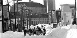 Residents walk down the center of a barely plowed Revere Street in the days after the Blizzard of '78.