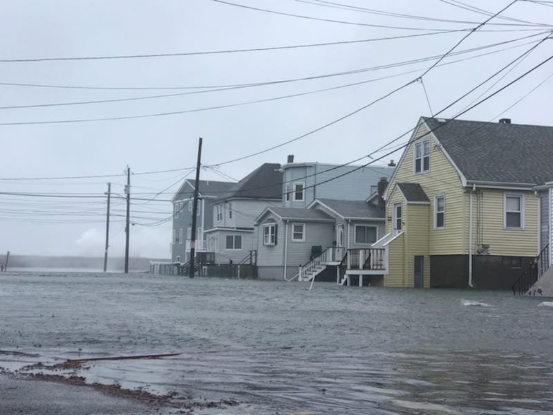 Pearl Street in Revere was underwater as the ocean crashed over the sea wall during high tide Friday morning.