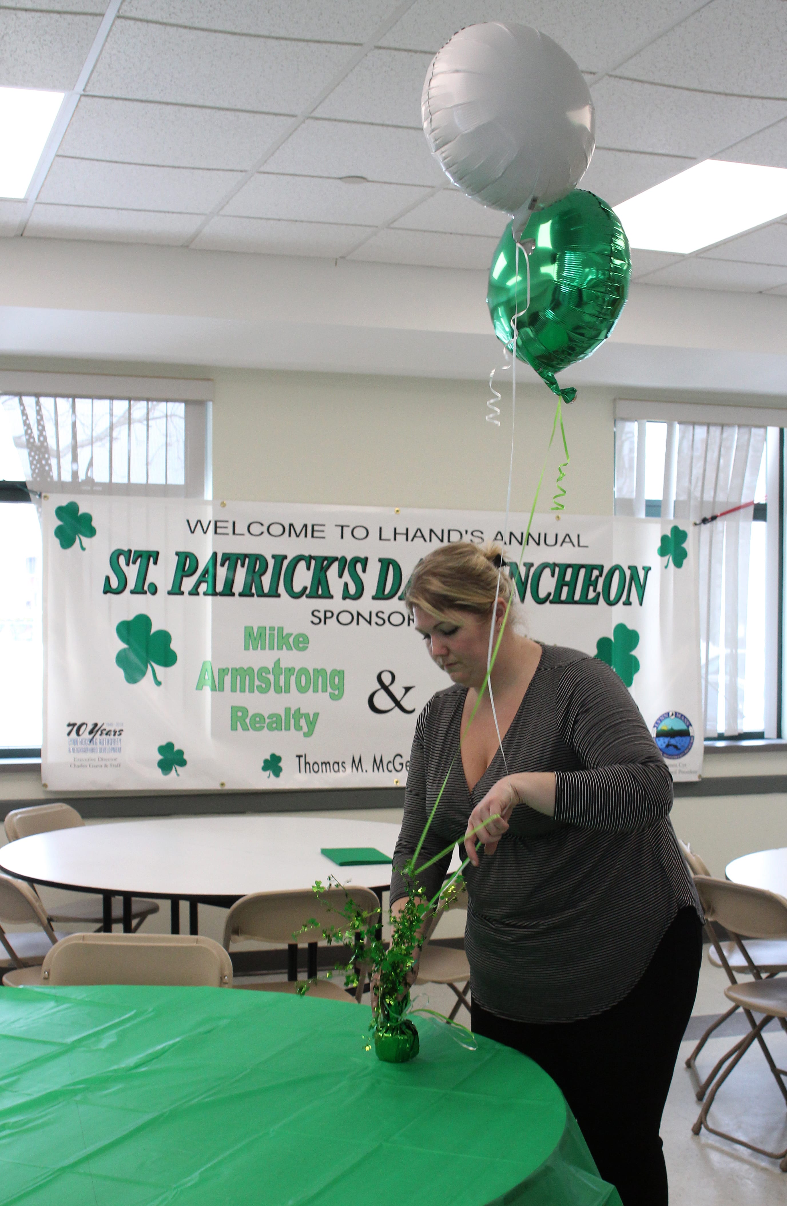 Lynn, Ma. 3-14-18. Cathy Rowe prepares the room at the Lynn Housing Authority & Neighborhood Development room for tomorrow's St. Patrick's Day lunch.