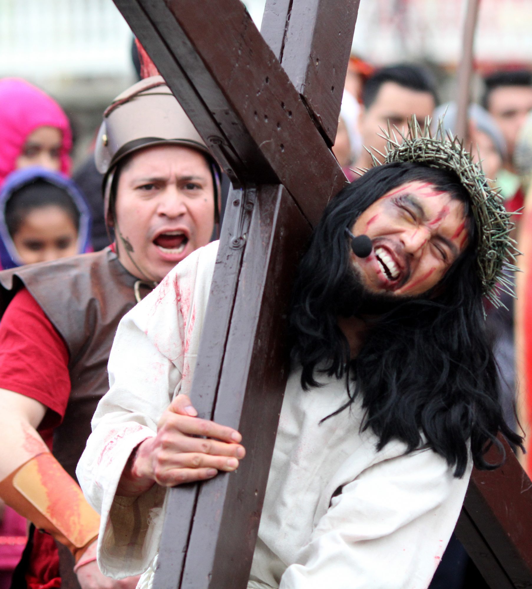 Lynn, Maq. 3-30-18. Jesus portrayed by Angel Perez, carries the cross on his way to Joseph Church on Union Street during the annual Good Friday procession.