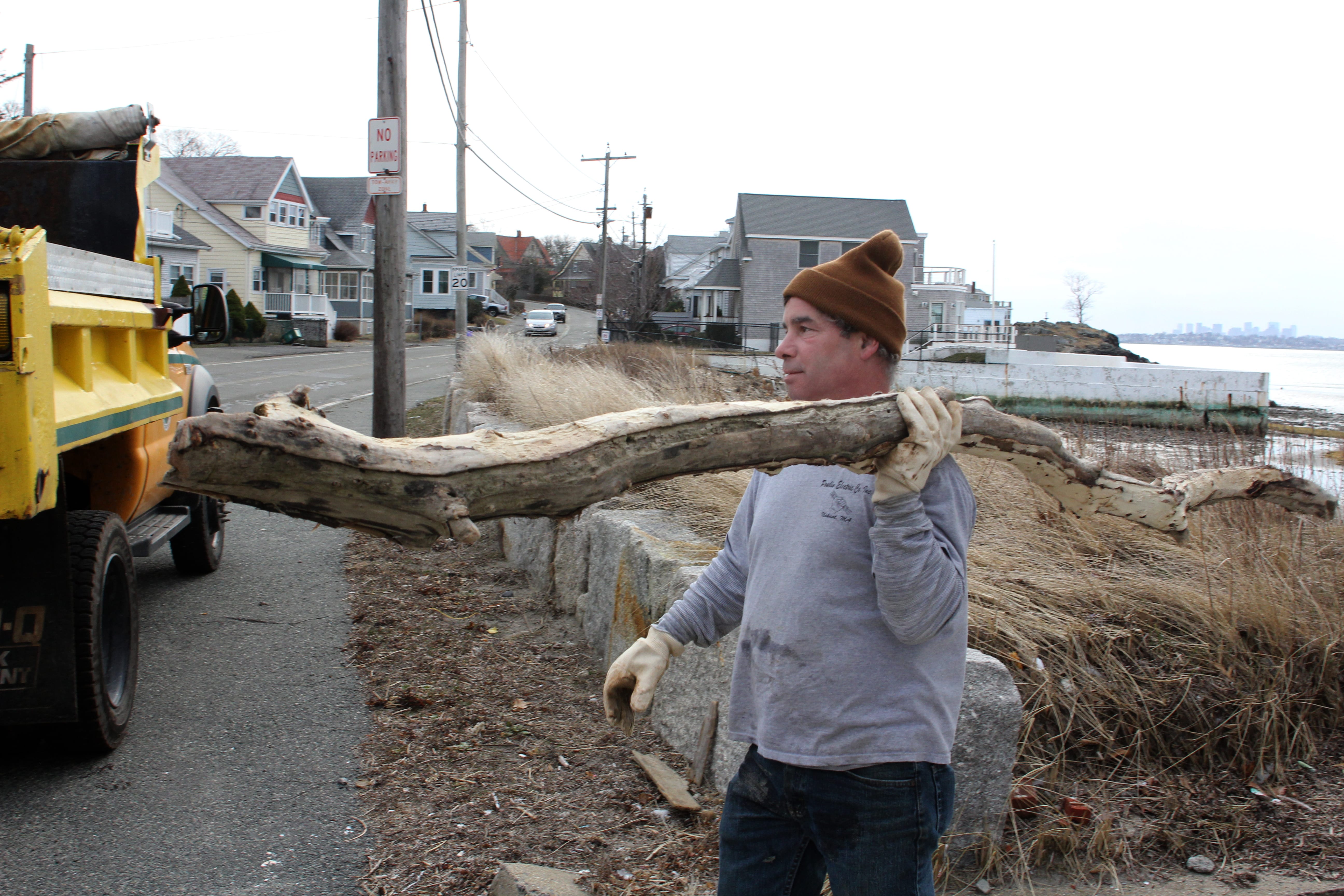 Nahant, Ma 3-1-18 Dan Gauvain, Nahant DPW, removes driftwood from a beach in Nahant before the storm throws it through the window of a house.