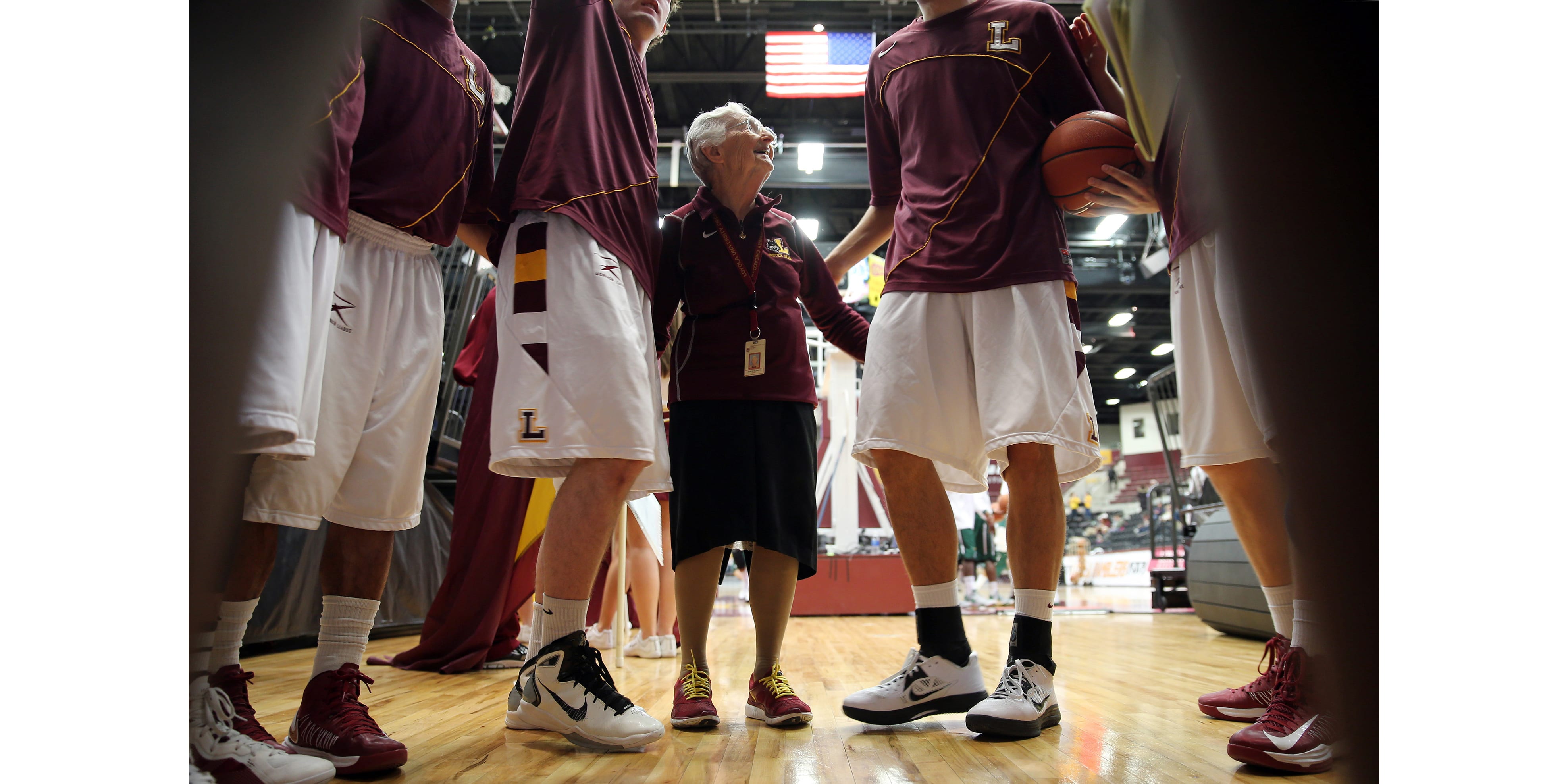 Sister Jean Dolores Schmidt says her pre-game prayer in the huddle before the game on Saturday in 2013.