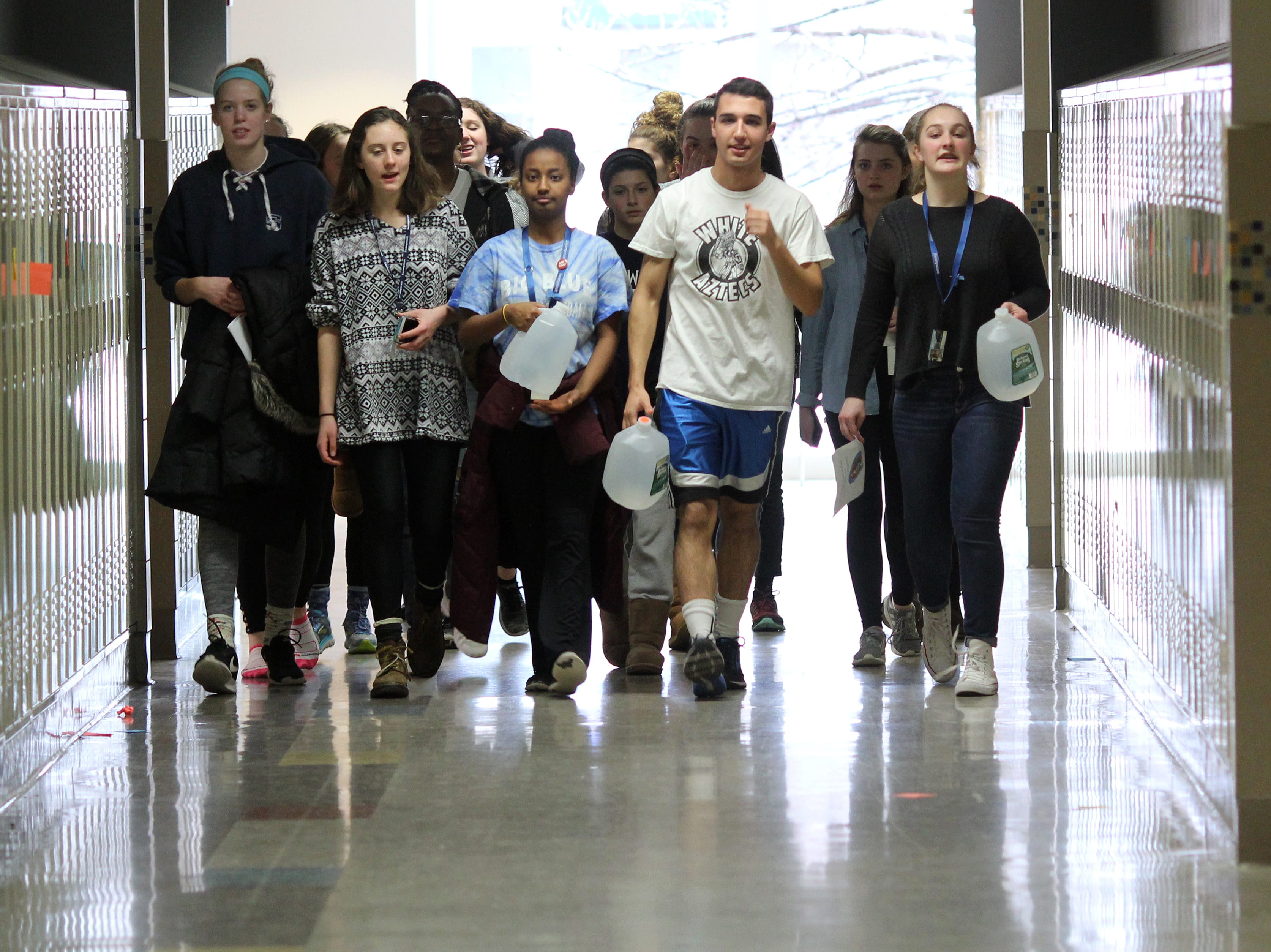 Swampscott, Ma. 3-22-18. Chrissy Rogers, Marley Schmidt, Mahder Teferra, Reece Klusza, and Mariel Flughum walk for water around the halls of Swampscott High School on World Water Day.