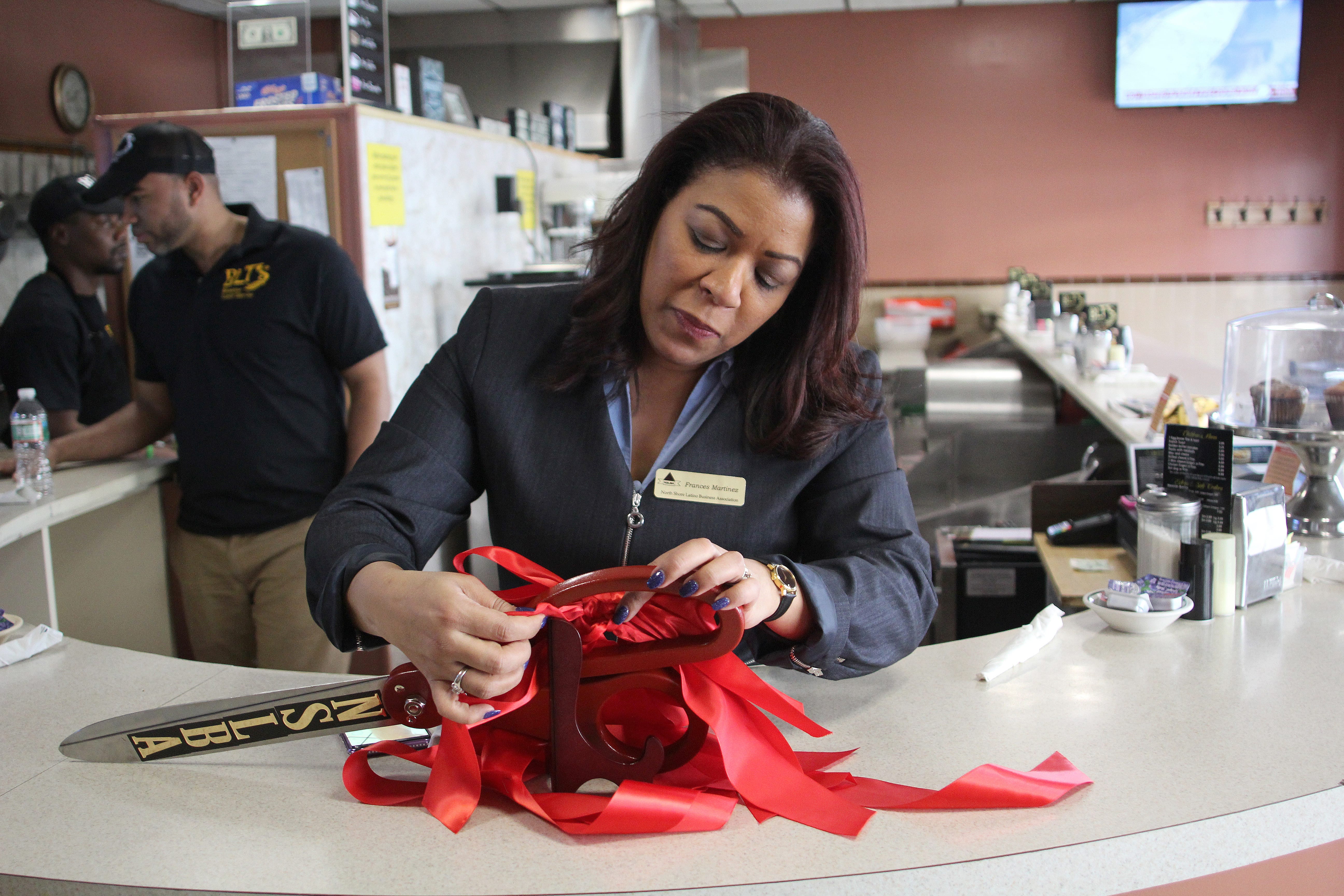 Lynn, Ma. 4-2-18. Frances Martinez, of the North Shore Latino Business Association, prepares for the grand reopening of BLT
