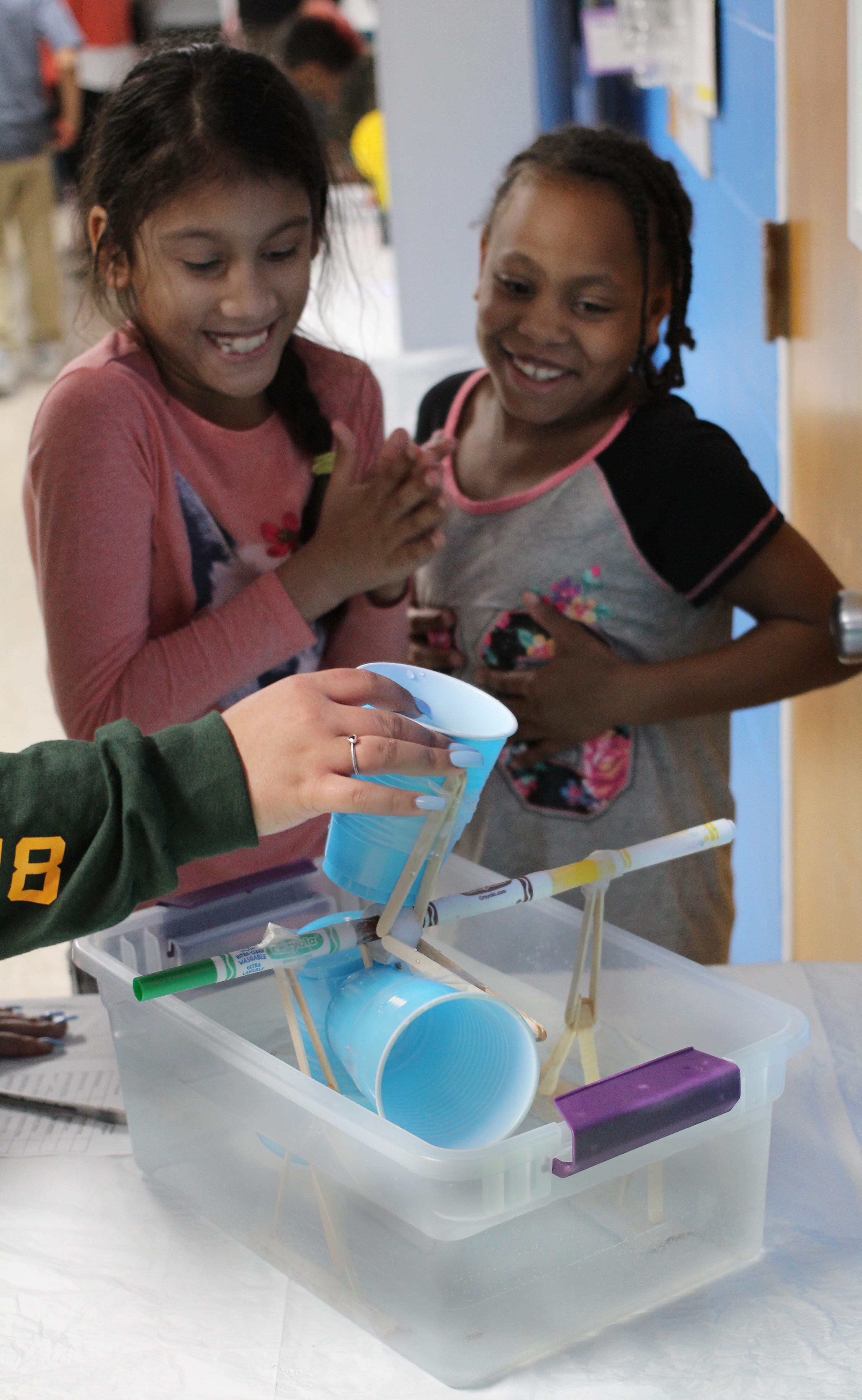 Lynn, Ma. 4-26-18. Aaliyah Grullard, left, and Kayla Corley, right with their science project Ancient Civilization water wheel at the science fair held at the Lynn YMCA.