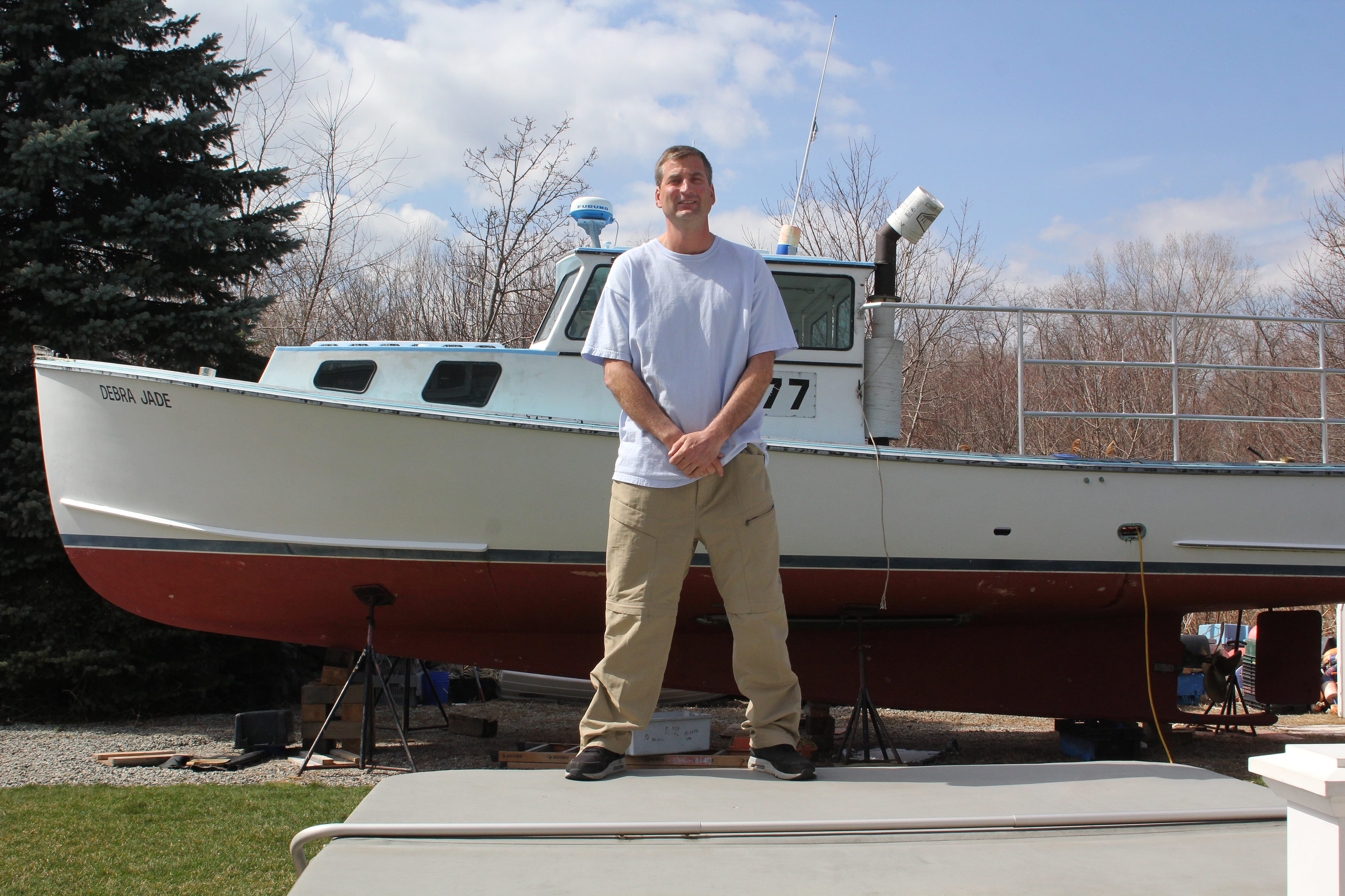 Nahant, Ma. 4-11-18. Justin Mahoney is a write-in candidate for selectman in Nahant. Behind him is the boat he uses to fish for lobsters.