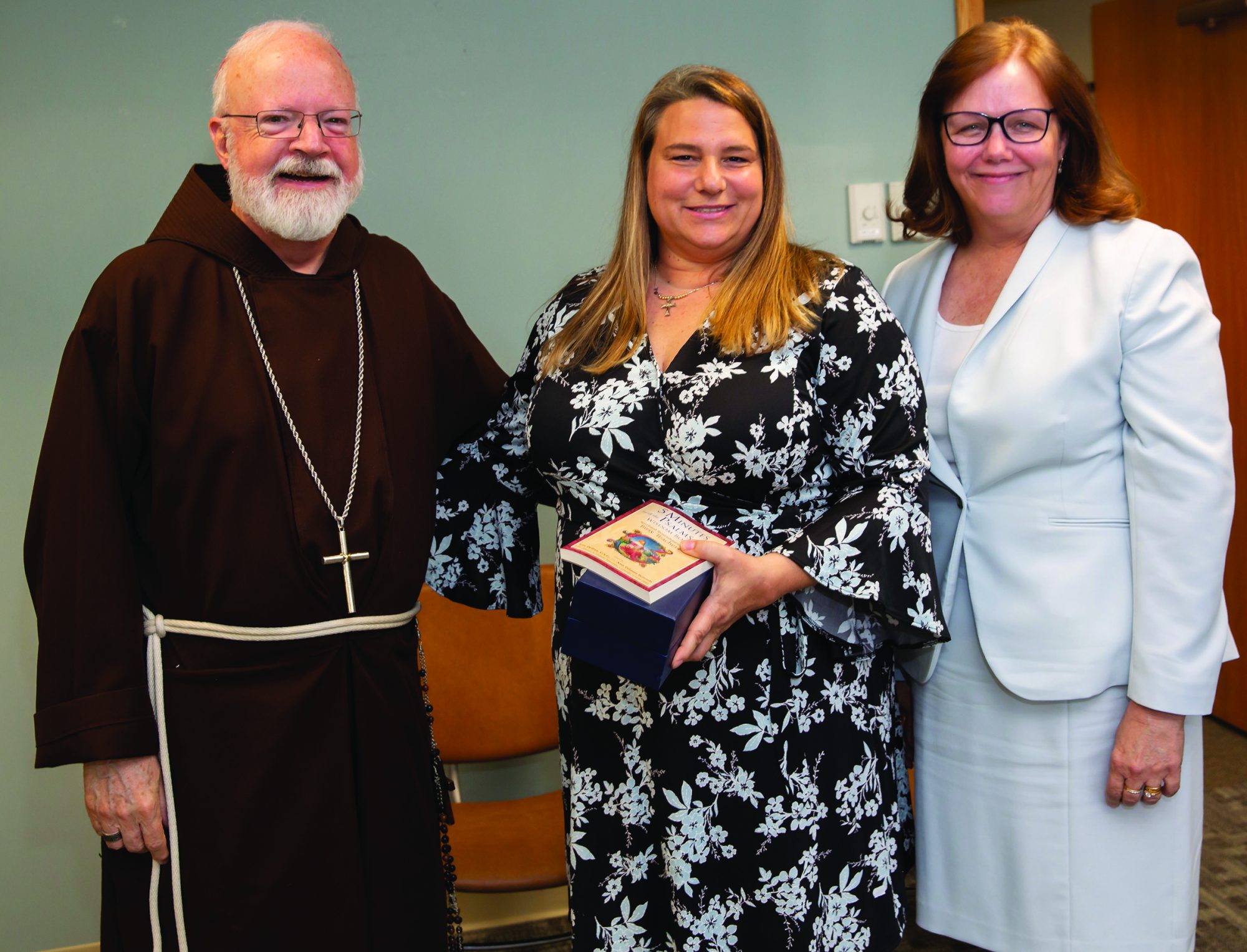 Andrea Alberti, center, with Cardinal Seán O’Malley and Kathy Mears, superintendent of the Archdiocese of Boston Catholic schools.