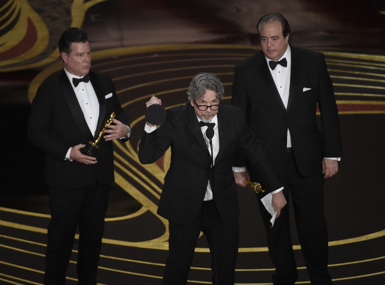 From left; Brian Hayes Currie, Peter Farrelly and Nick Vallelonga accept the award for best original screenplay for 