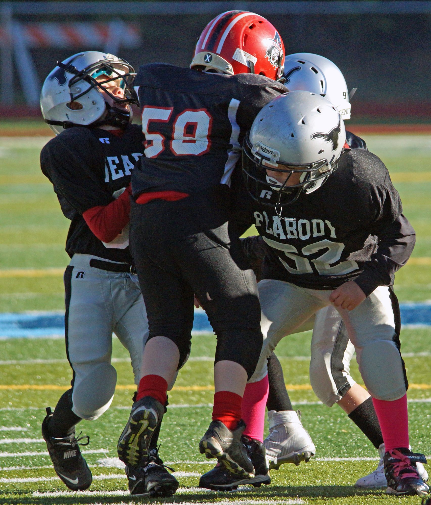 Peabody and Salem youth football players going head to head.