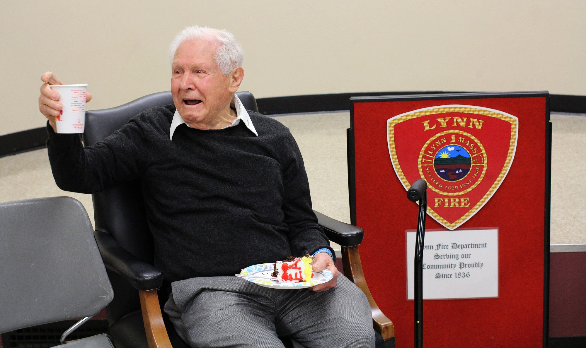 Rocco "Rocky" M. Brienzo enjoys some birthday goods during his 100th birthday celebration at Lynn City Hall.