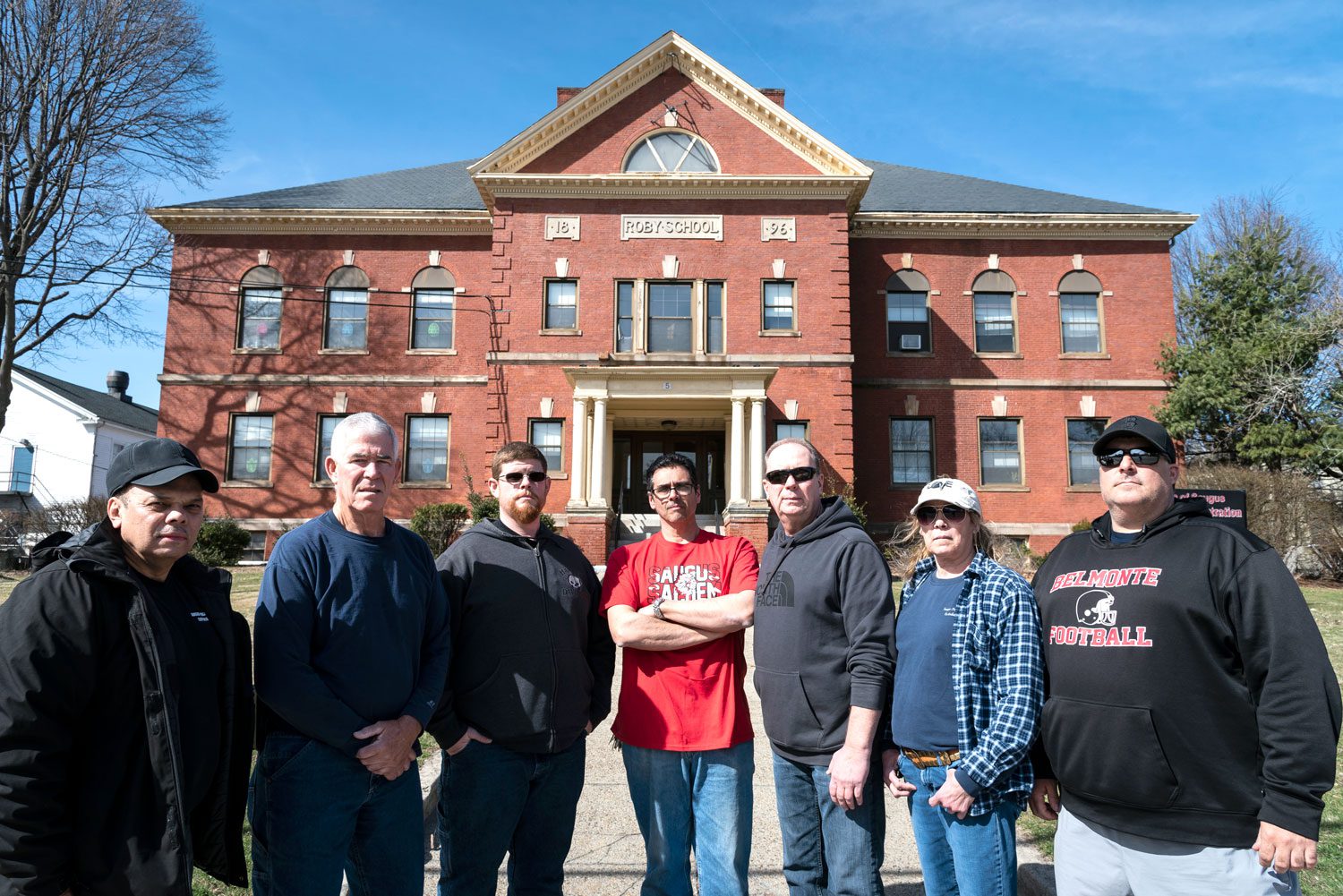 Saugus school custodians including, from left, Carlos Gonzalez, John McBride, Tom Lowe, Steve Raso, Rick Nelson, Angela McGeorge and Michael Mabee might lose their jobs if the town decides to privatize custodial services.