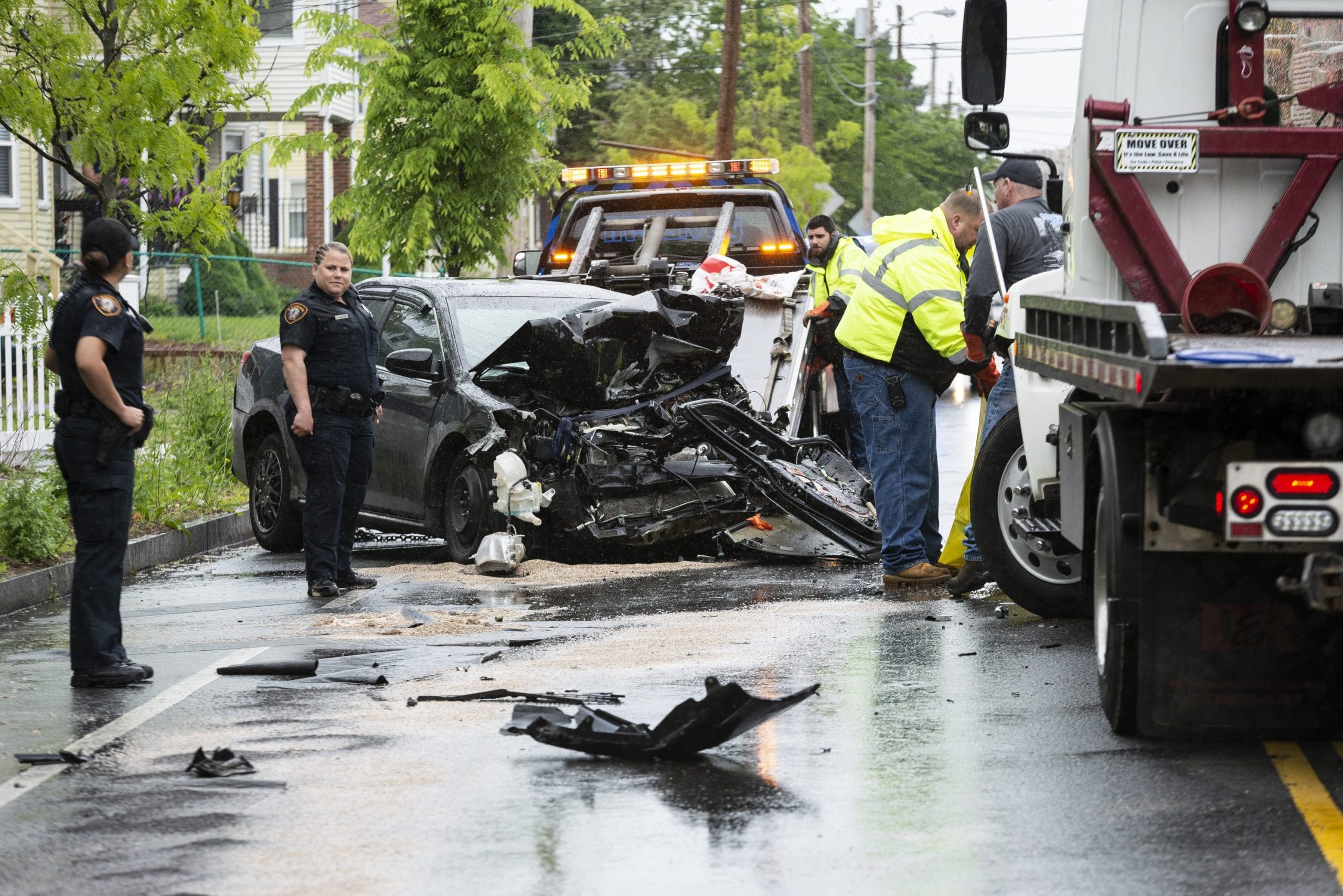 First responders and crews work to clean up a head-on collision between a tow truck and sedan on Lincoln Avenue in Saugus Tuesday afternoon.