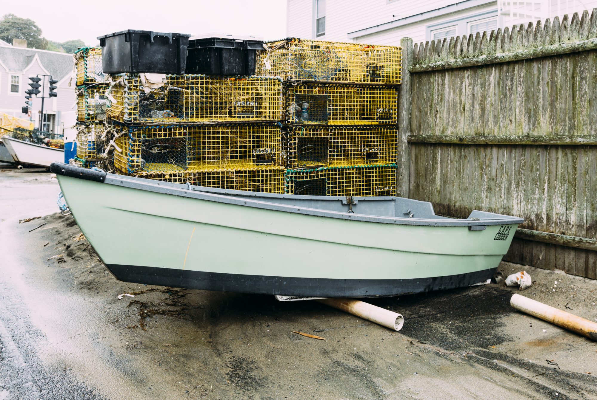 A dory sits next to fishing traps at the Swampscott Fish House.