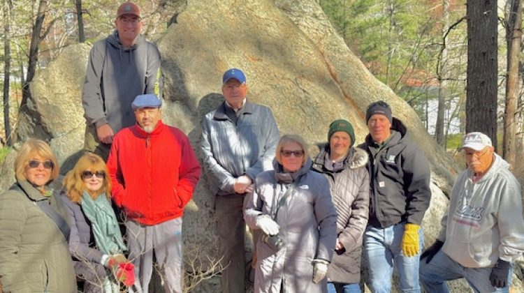 A group of intrepid hikers pose with geologist Nick Federico in front of the Willis Woods Glacial Erratic